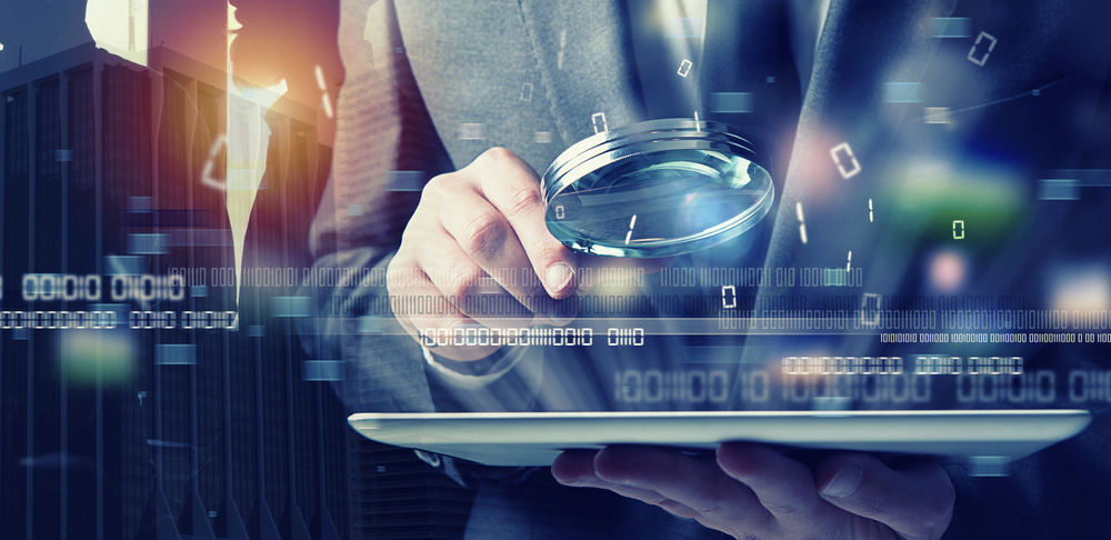 Businessman using a tablet to review an AI in account-based experience strategy.